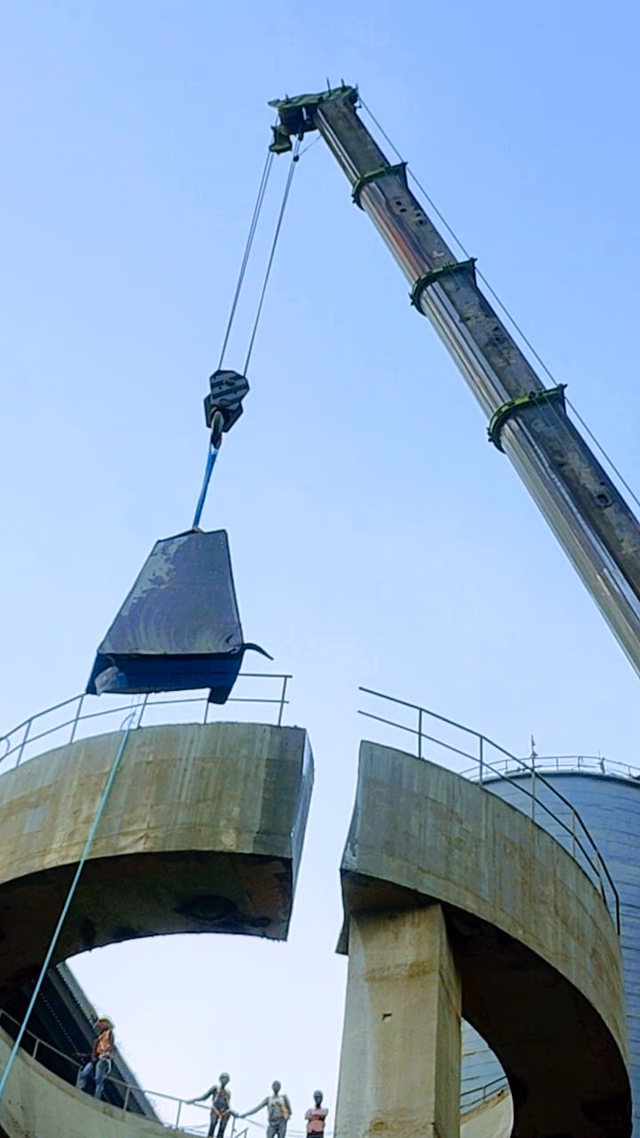 High-Reach Excavator Breaking Concrete Slab